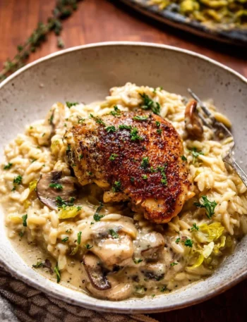 Slow Cooker Mustard Herb Chicken served with creamy orzo on a plate