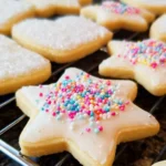 Soft cut-out sugar cookies decorated with icing and sprinkles.