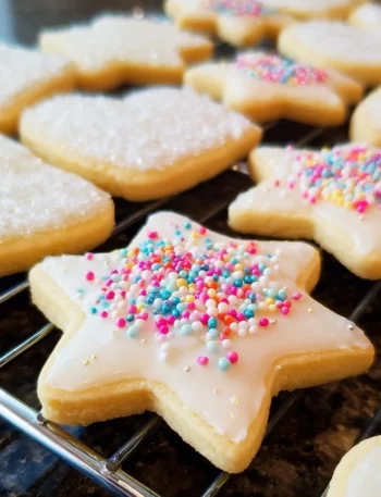 Soft cut-out sugar cookies decorated with icing and sprinkles.