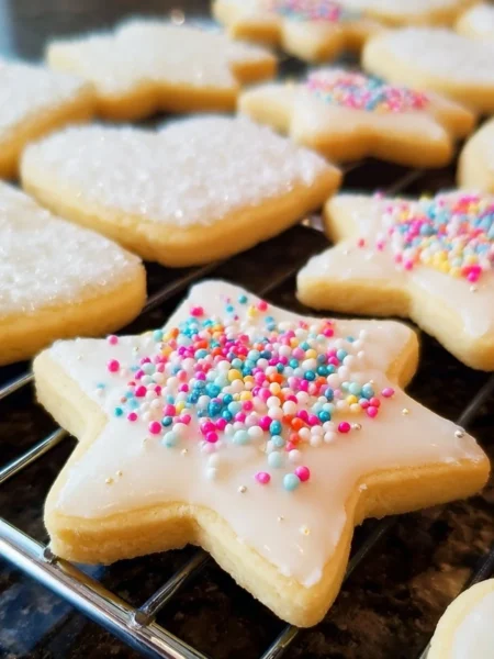 Soft cut-out sugar cookies decorated with icing and sprinkles.