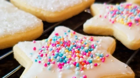 Soft cut-out sugar cookies decorated with icing and sprinkles.