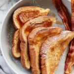 Delicious fluffy French toast made with eggs, milk, and sugar served on a plate.