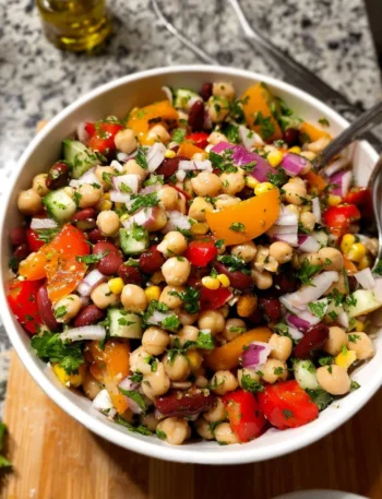 Colorful and nutritious dense bean salad with a variety of beans and vegetables