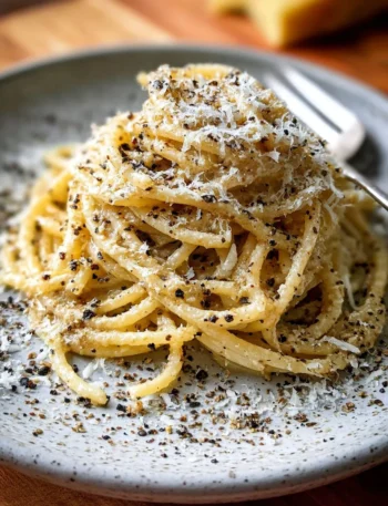 Bowl of gluten-free cacio e pepe with cheese and pepper seasoning