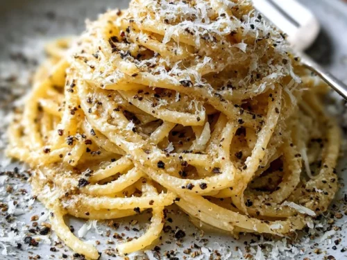 Bowl of gluten-free cacio e pepe with cheese and pepper seasoning