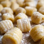 A delicious plate of homemade gluten-free gnocchi topped with fresh herbs.